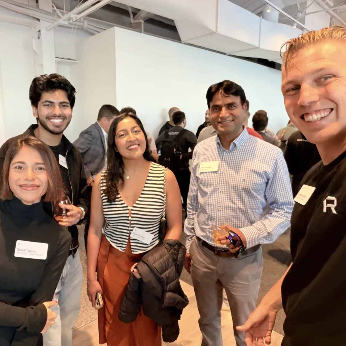 Selfie of Jono and Sne with three people from the Datadog team, holding drinks at the Vercel partner event